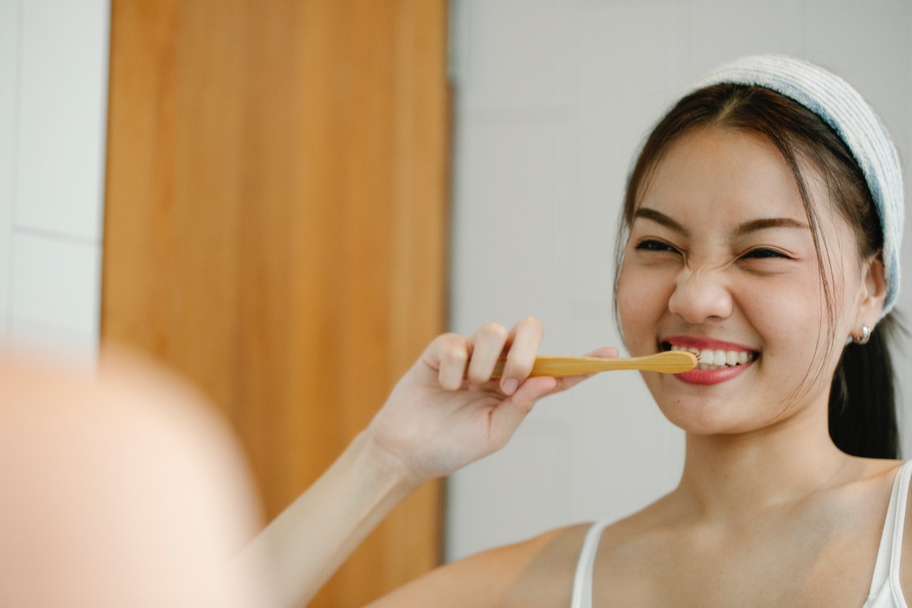 Young lady brushing her teeth