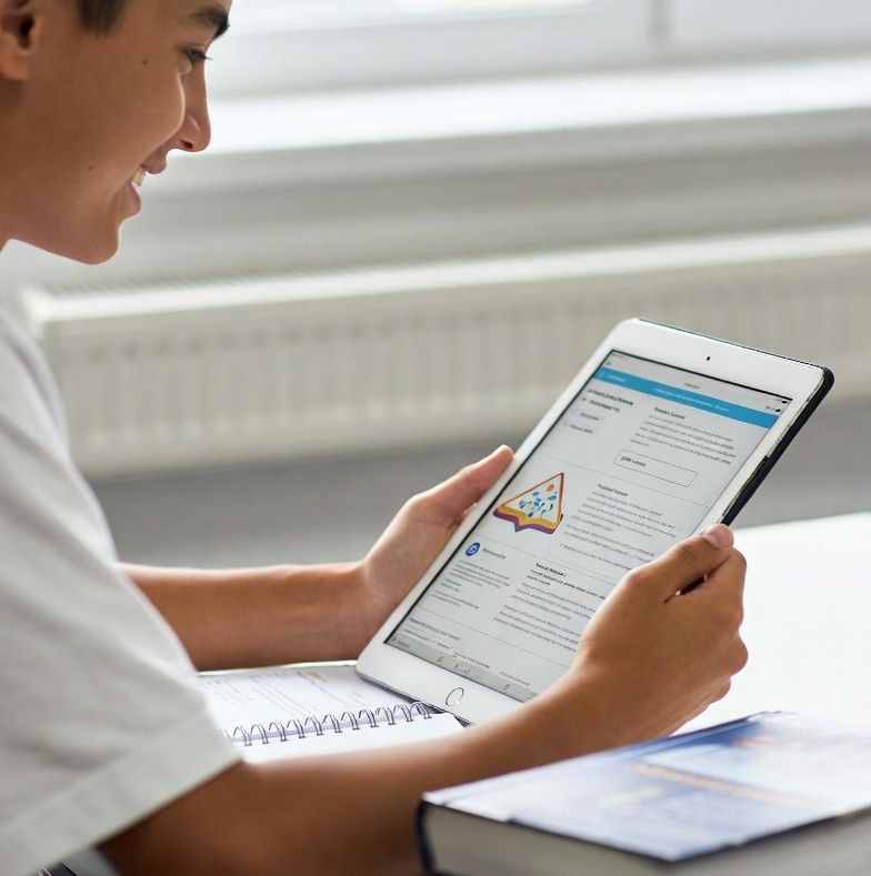 student happily holding a tablet with study materials